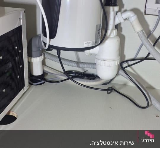 מערכת צינורות וניקוז מתחת לכיור מטבח